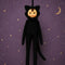 cute plush dressed as a black cat and has a vintage circle face