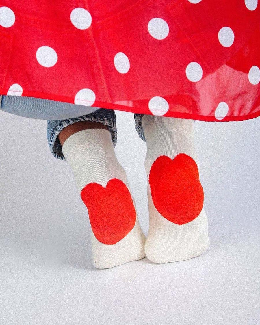 model wearing white socks with red hearts on the heels