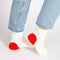 side view of model wearing white socks with red hearts on the heels
