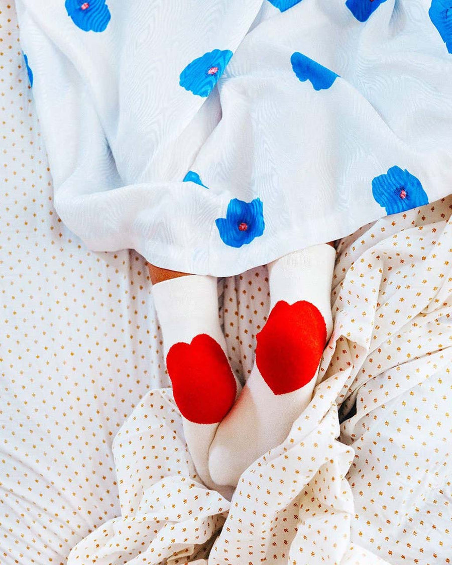 model wearing white socks with red hearts on the heels
