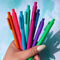 model holding set of 8 colorful gel pens