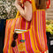 model carrying orange, yellow, and pink vertical stripe recycled plastic tote with ribbon detail and lemon applique