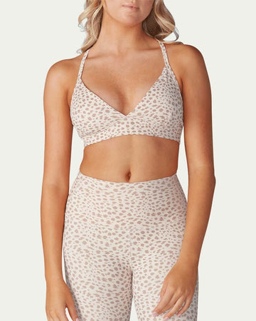 model wearing white adjustable studio bra with tan subtle leopard print