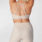 back view of model wearing white adjustable studio bra with tan subtle leopard print