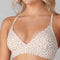 up close of model wearing white adjustable studio bra with tan subtle leopard print