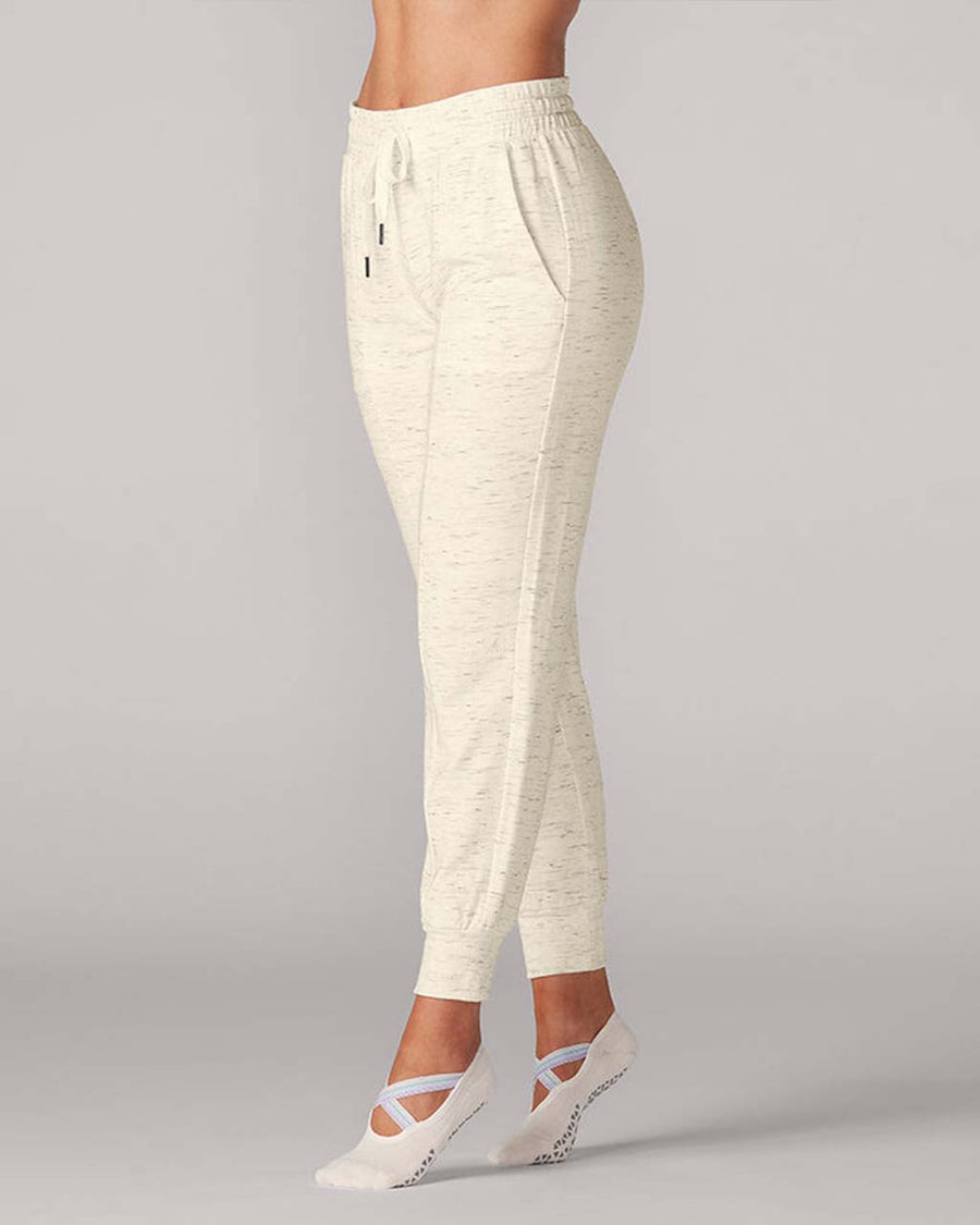 model wearing cream jogger pants with grey speckles
