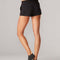 back view of model wearing black comfy shorts with elastic waist and drawstring