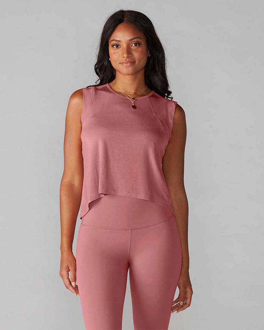 model wearing dark pink active tank with hi-lo hem and muscle tank sleeves