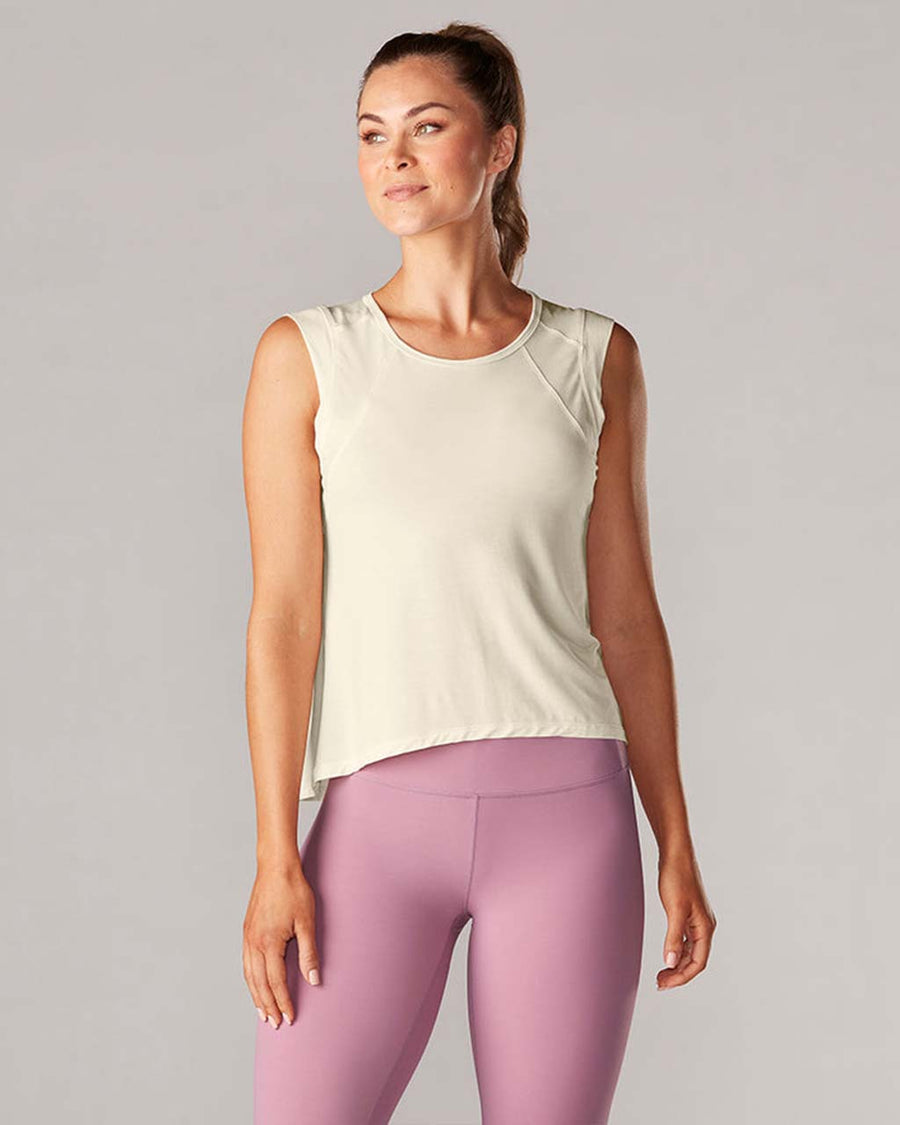 model wearing sand active tank with hi-lo hem and muscle tank sleeves