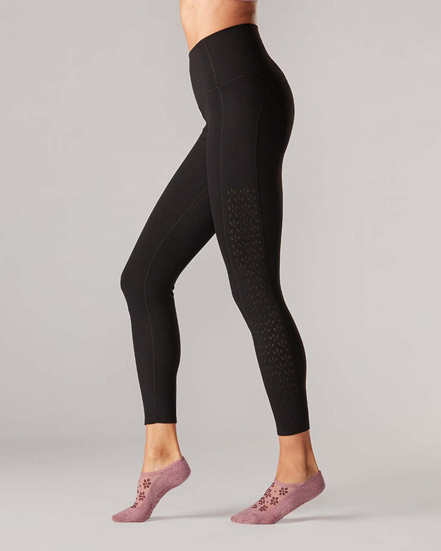model wearing black high waist leggings with leg eyelet detail
