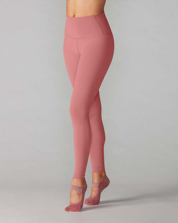 model wearing high waist leggings in a dark mauve color