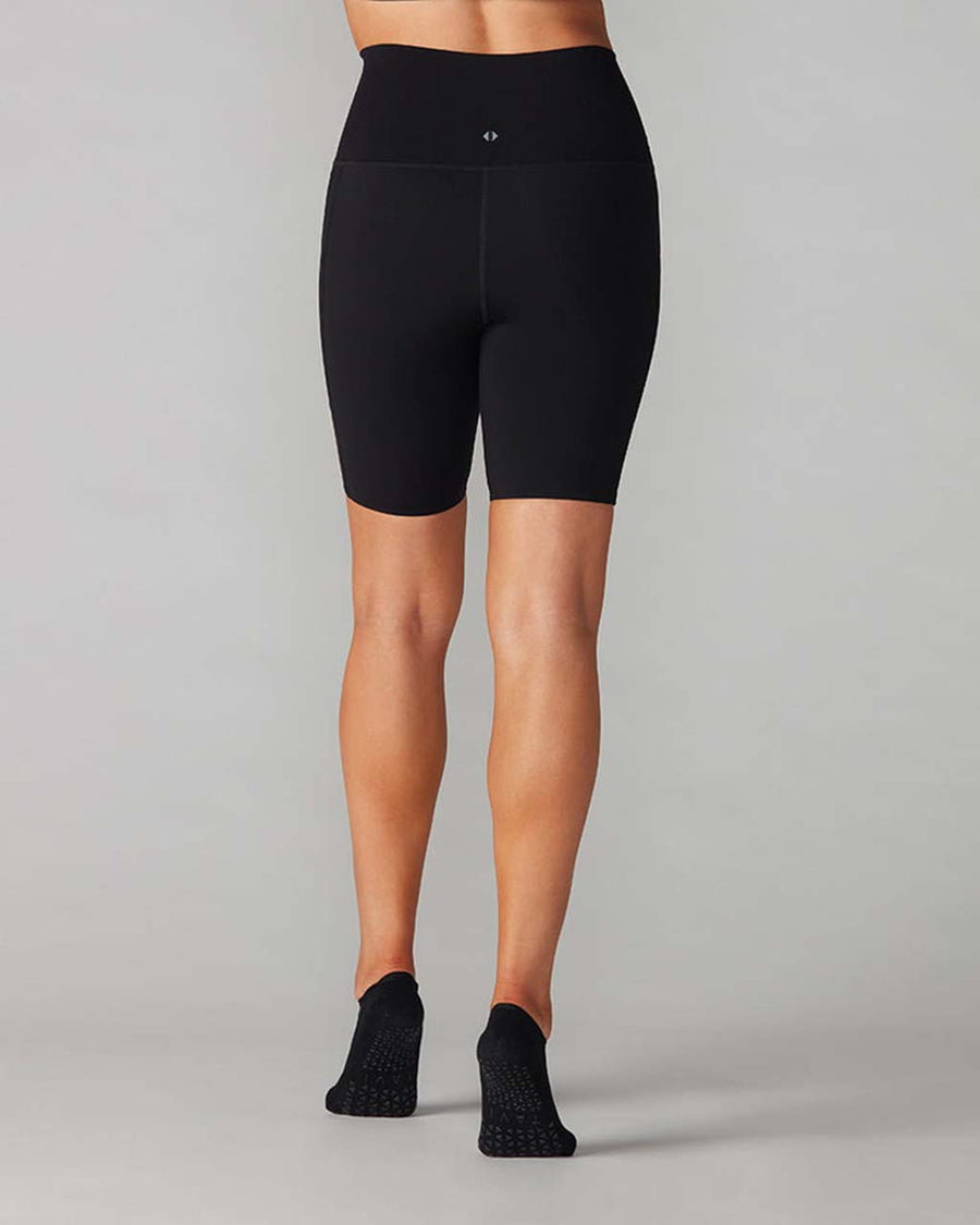back view of model wearing black biker shorts with side pockets