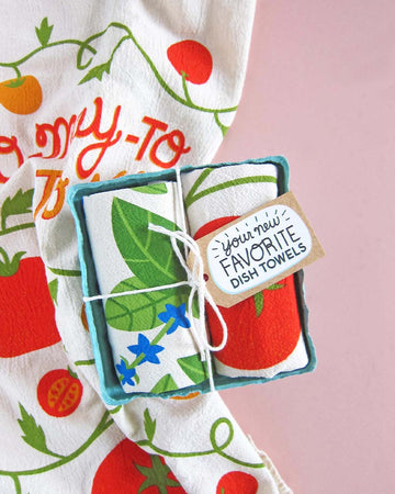 set of 2 tea towels with tomato and basil prints in a biodegradable container
