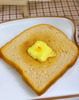 up close of lit realistic buttered toast candle