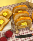 several realistic buttered toast candles