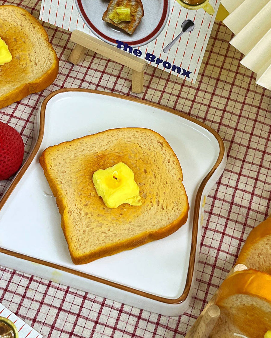 lit realistic buttered toast candle