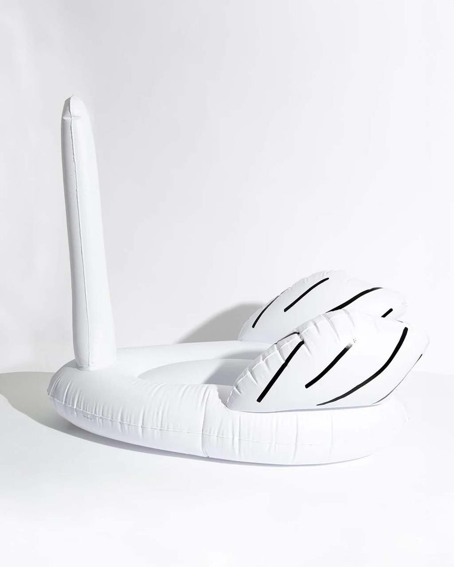 side view of white inflatable ridiculous 'swan thing' pool float