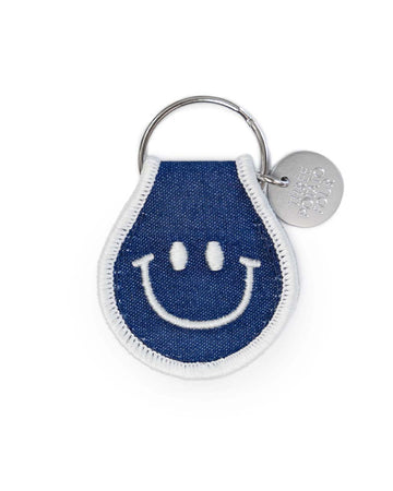 denim patch keychain with white smiley face and trim