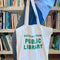 model holding white tote with 'materials from public library' in kelly green