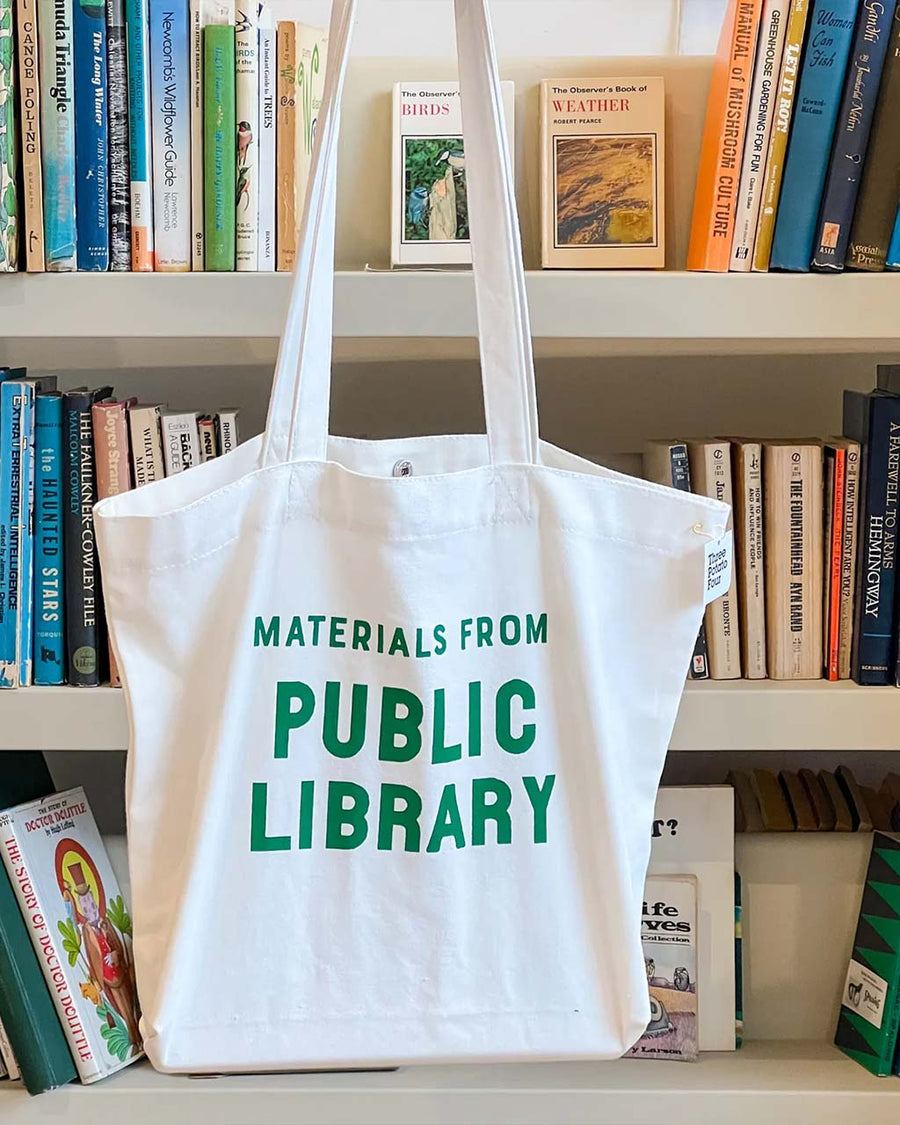 white tote with 'materials from public library' in kelly green