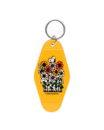 yellow key tag with snoopy and his doghouse surrounded by daisies