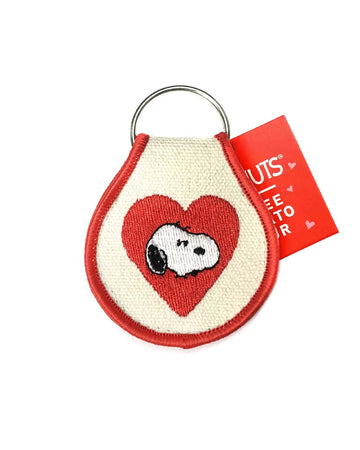 tan patch keychain with snoopy face and a red heart and red trim