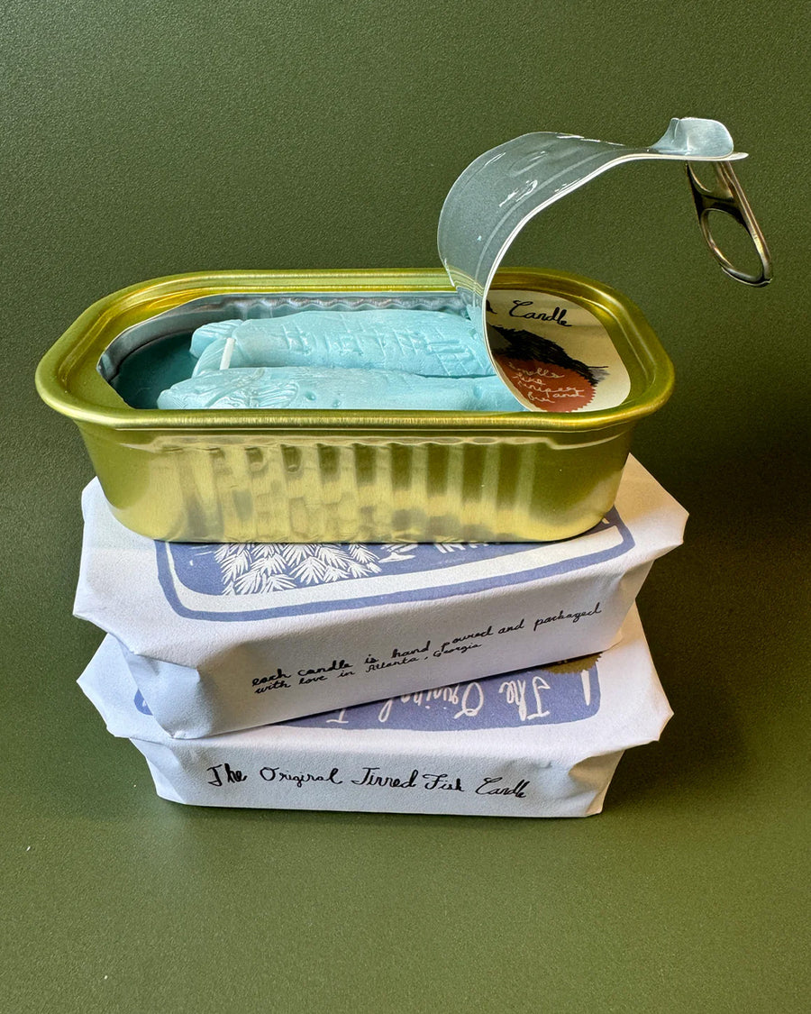 opened juniper and fraser fir scented candle in a fish tin with fish candle inside