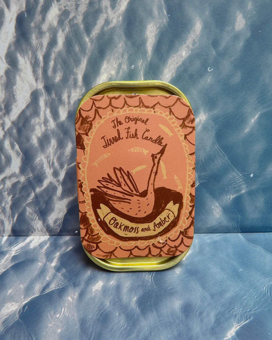 packaged oakmoss and amber scented candle in a fish tin with fish candle inside