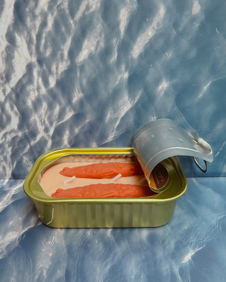 sideview of opened oakmoss and amber scented candle in a fish tin with fish candle inside