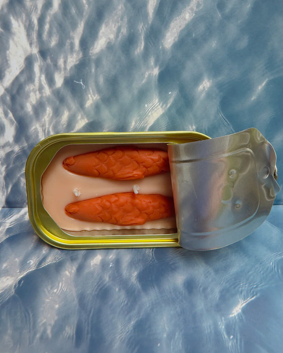 opened oakmoss and amber scented candle in a fish tin with fish candle inside