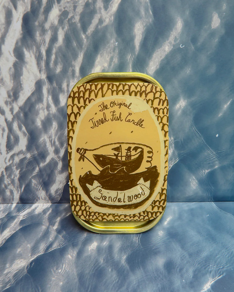 packaged sandal scented candle in a fish tin with fish candle inside