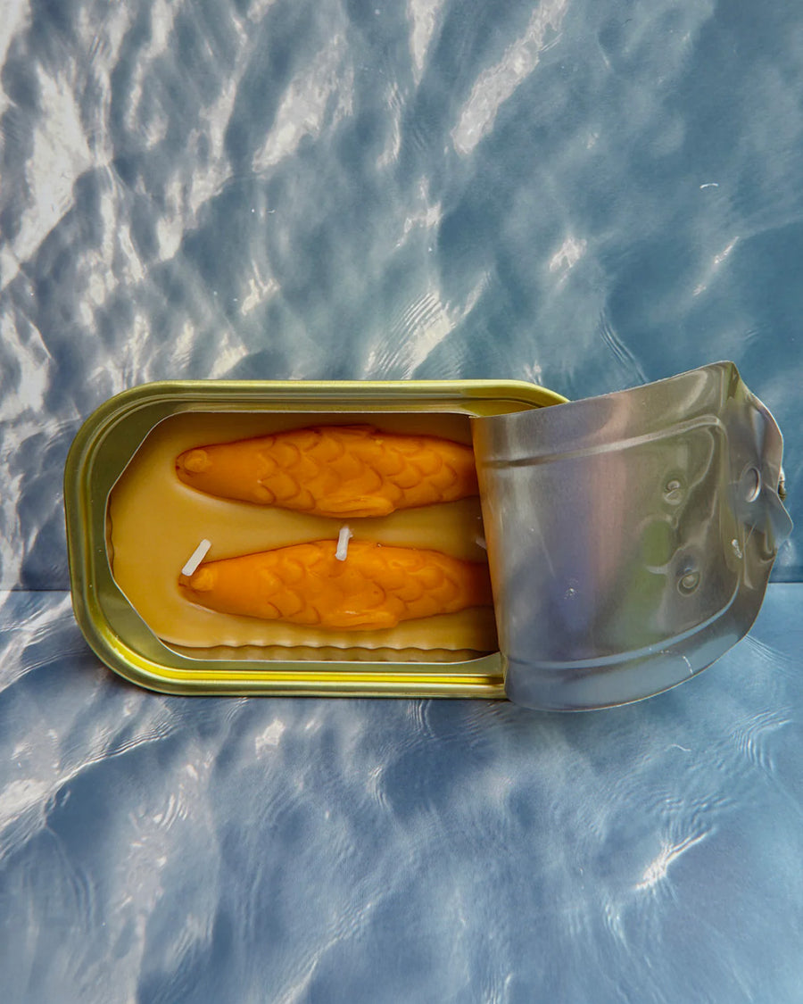 opened sandal scented candle in a fish tin with orange fish candle inside