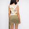 back view of model wearing white tank with colorful seashell print and blue trim