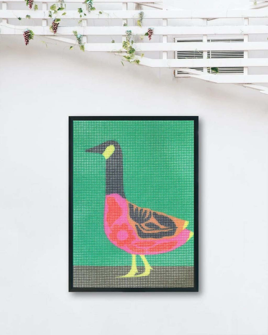 folk goose needlepoint hanging on a wall