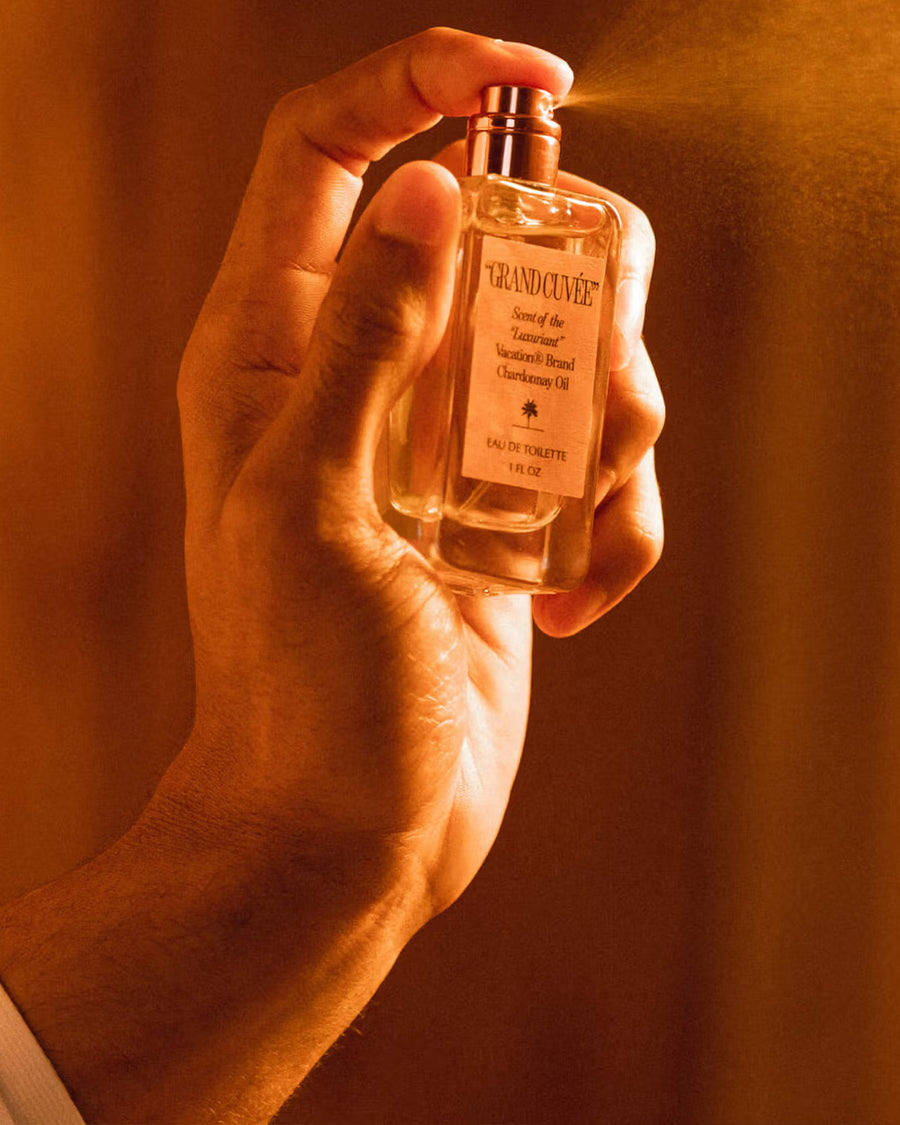 model spraying grand cuvee eau de toilette bottle and box