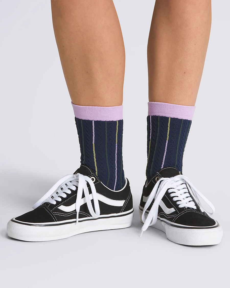 model wearing blue socks with lavender trim and colorful vertical stripes