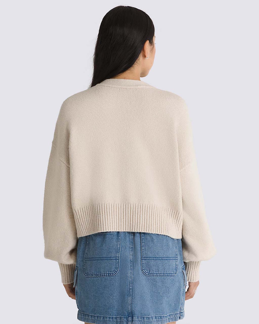 back view of model wearing oatmeal cropped cardigan sweater with balloon sleeves