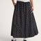 model wearing black skirt with white polka dot print