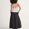 back view of model wearing black skirt with white polka dot print