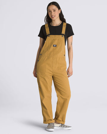 model wearing mustard yellow cotton canvas overalls with black tee