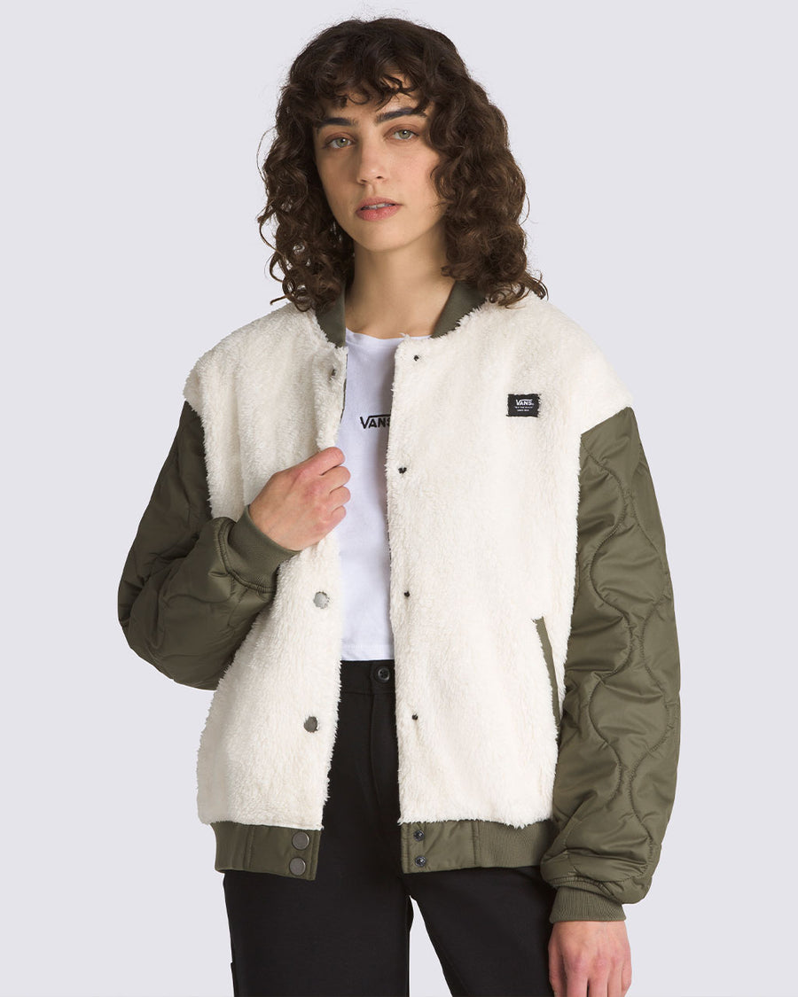 model wearing white sherpa jacket with green quilted sleeves