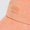 up close of peach ribbed hat with embroidered vans detail