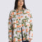 model wearing cream oversized button down shirt with colorful abstract print