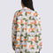 back view of model wearing cream oversized button down shirt with colorful abstract print
