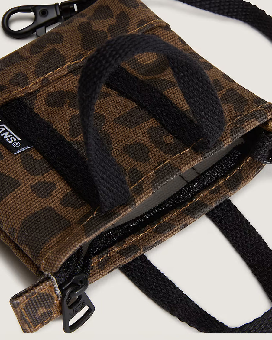 up close of brown and black trippy checker key charm with black straps and vans logo on the front