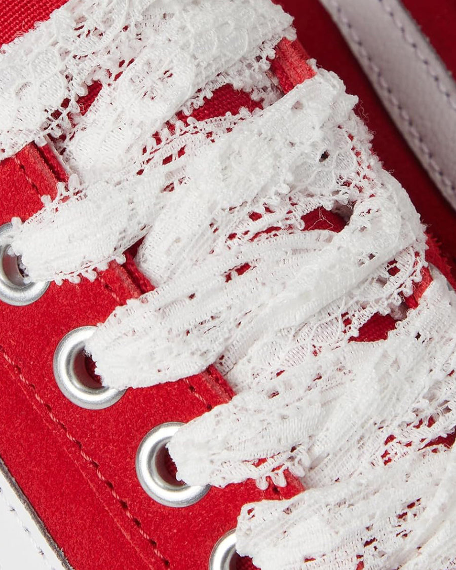 up close of red old skool sneaker with white and red lace laces