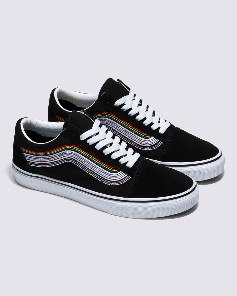 pair of black old skool shoes with embroidered rainbow stripe