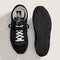 top and bottom view of black vans super low pro trainer sneakers  with white laces