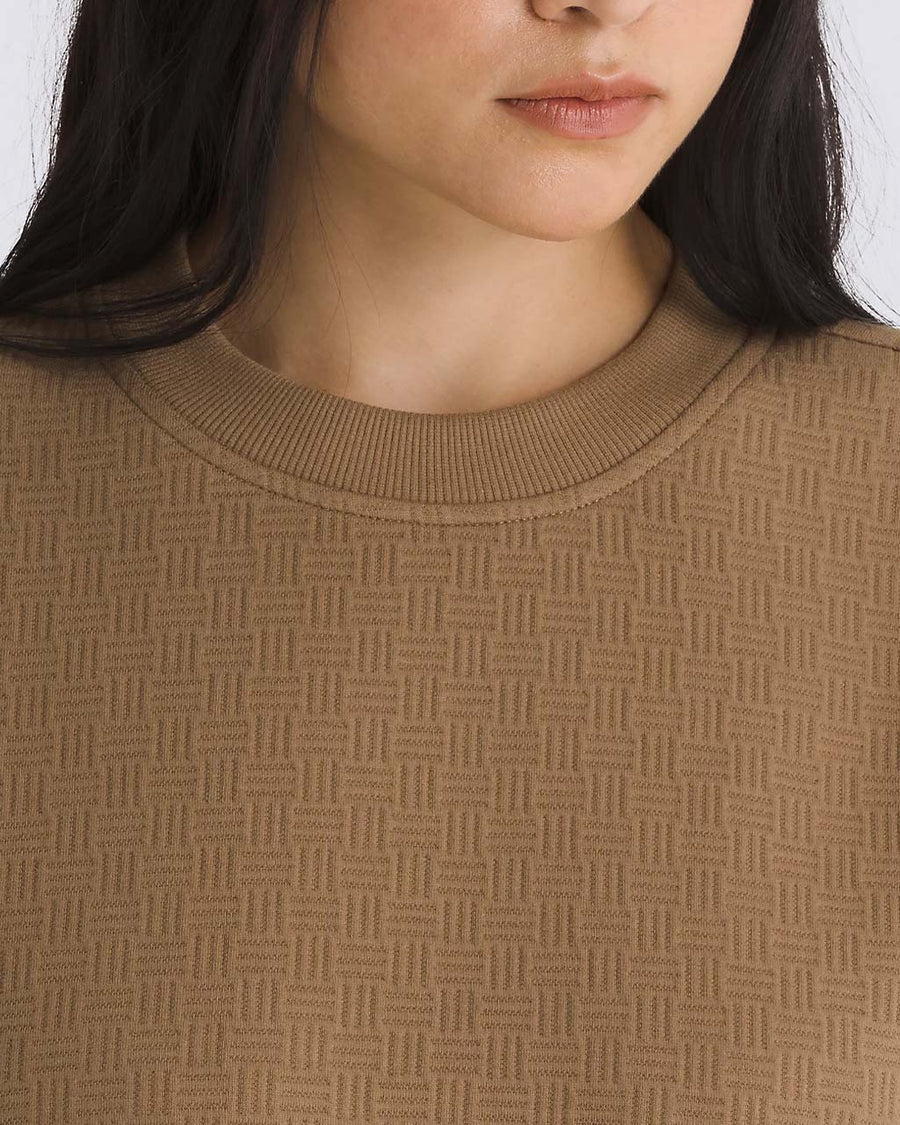 up close of model wearing brown jacquard relaxed fit sweatshirt
