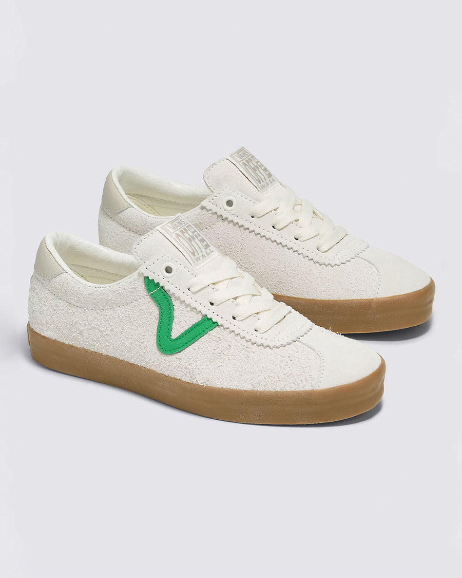 white vans sport low sneakers with green iconic vans stripe